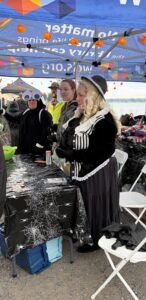 Crew standing behind table handing out treats