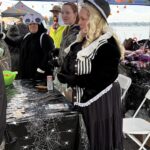 Crew standing behind table handing out treats
